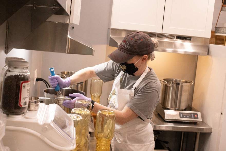Woman mixing syrup in a kitchen