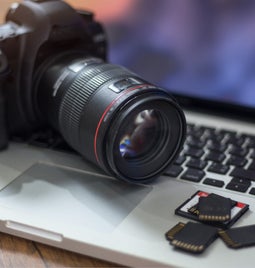 Camera resting on a laptop