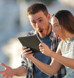 Couple are amazed at content they see on a tablet
