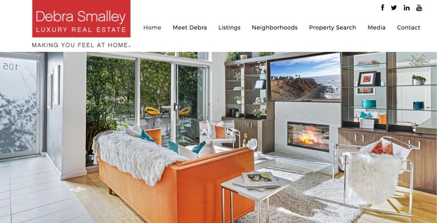 DS Web banner for Debra Smalley Luxury Real Estate showcasing an elegant interior with a view of a hillside, embodying the comfort and style of high-end living.