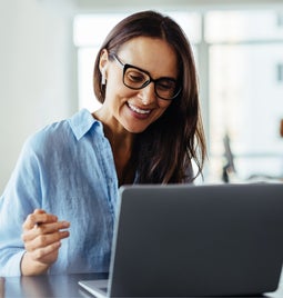 woman smiling at laptop computer