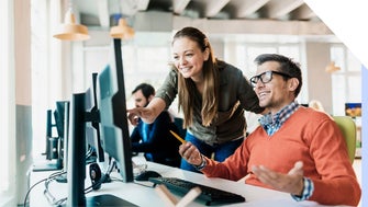 Man and woman work at same desktop screen