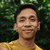 Headshot of Bayu smiling, wearing a tan t-shirt