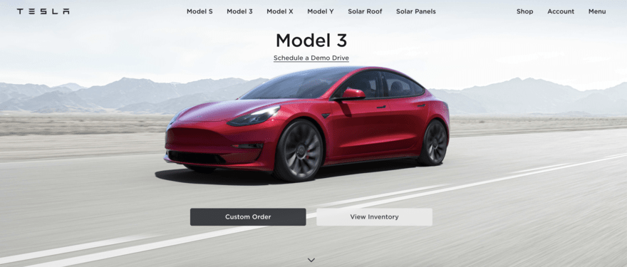 Tesla homepage shows red car driving on road