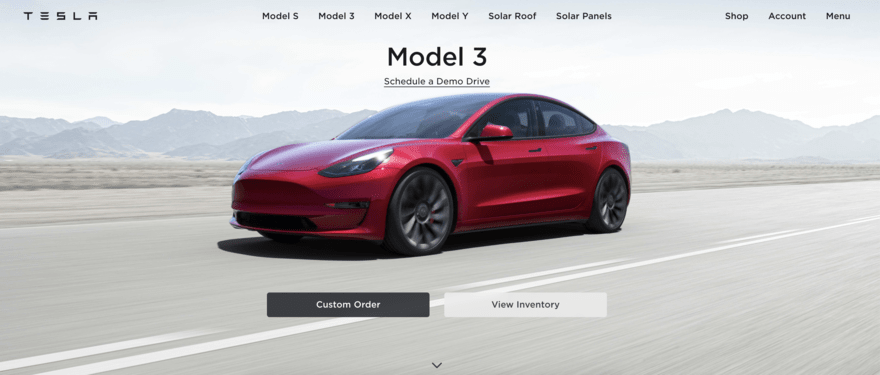 Tesla’s mission statement Tesla homepage shows red car driving on road