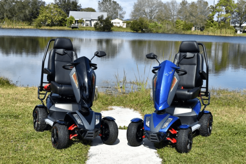 Screenshot 2023-08-25 105911 two mobility scooters by a lake