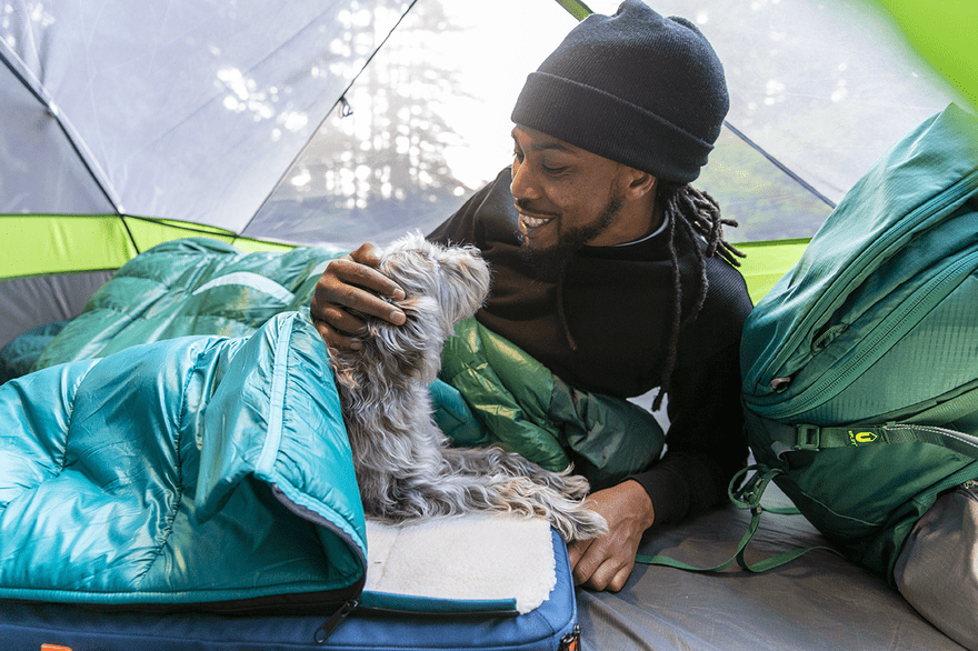 Timberdog product photo Man in a tent with a dog using a pet bed/sleeping bag