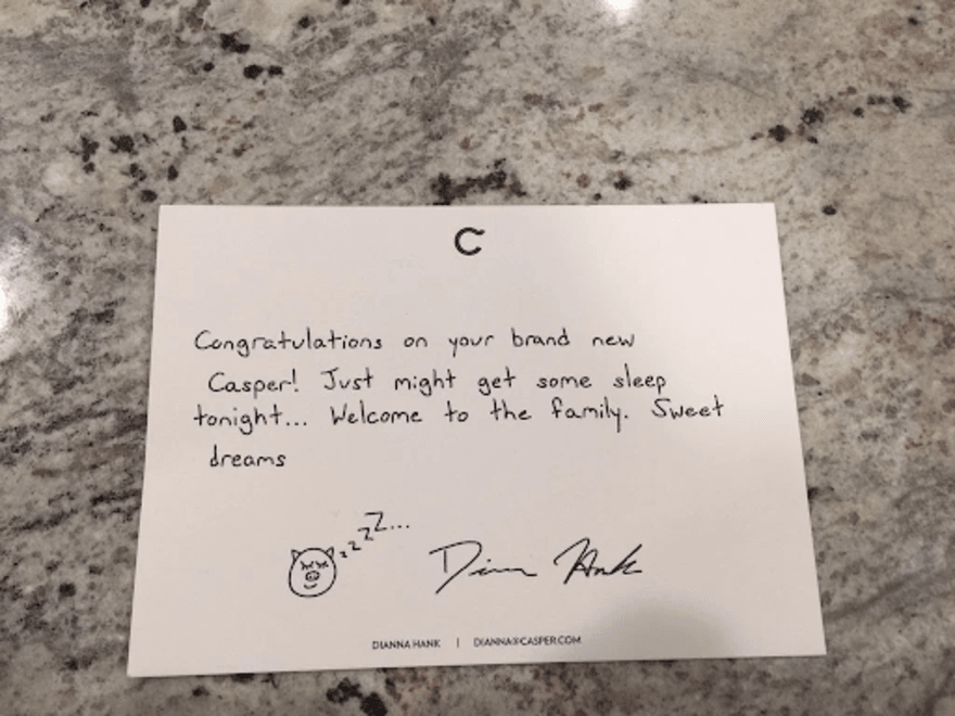 A handwritten thank you note from bed brand Caspar placed on a granite countertop