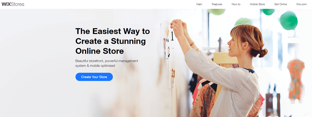wix ecommerce homepage Wix eCommerce landing page with woman hanging necklaces on a wall